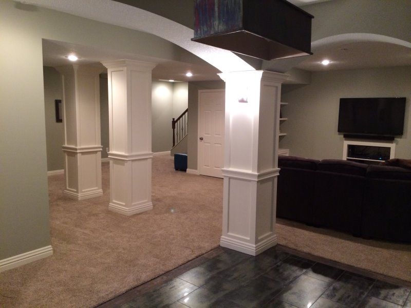 Full basement remodel with custom arch openings and tile flooring