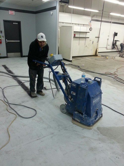 Grind floor to remove coating & prep for new epoxy-urethane coating