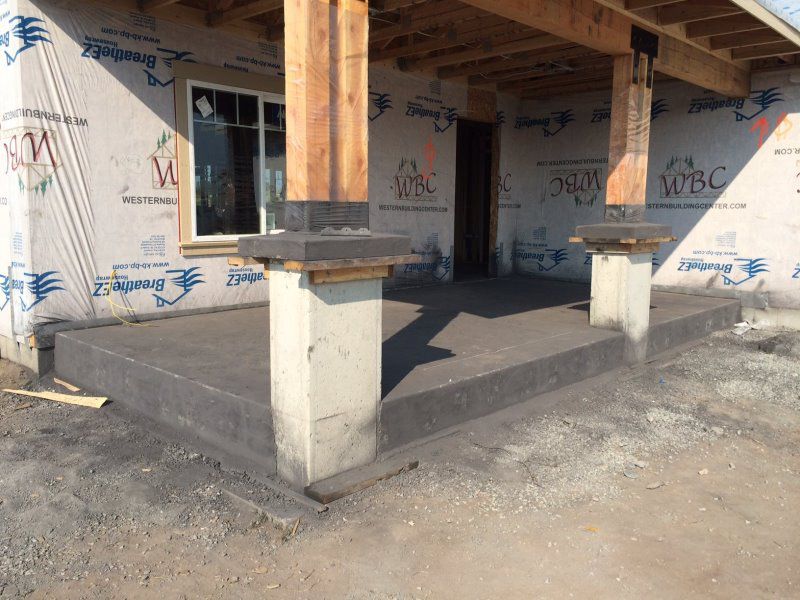 Black stamped concrete porch, concrete caps, concrete column
